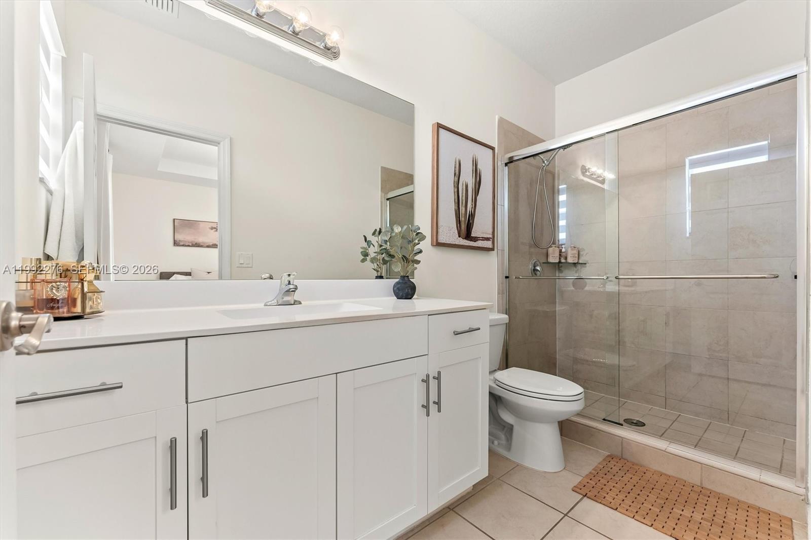10487 West 34th Court Hialeah, FL 33018 - Photo 24 of 57 a bathroom with a double vanity sink toilet and shower