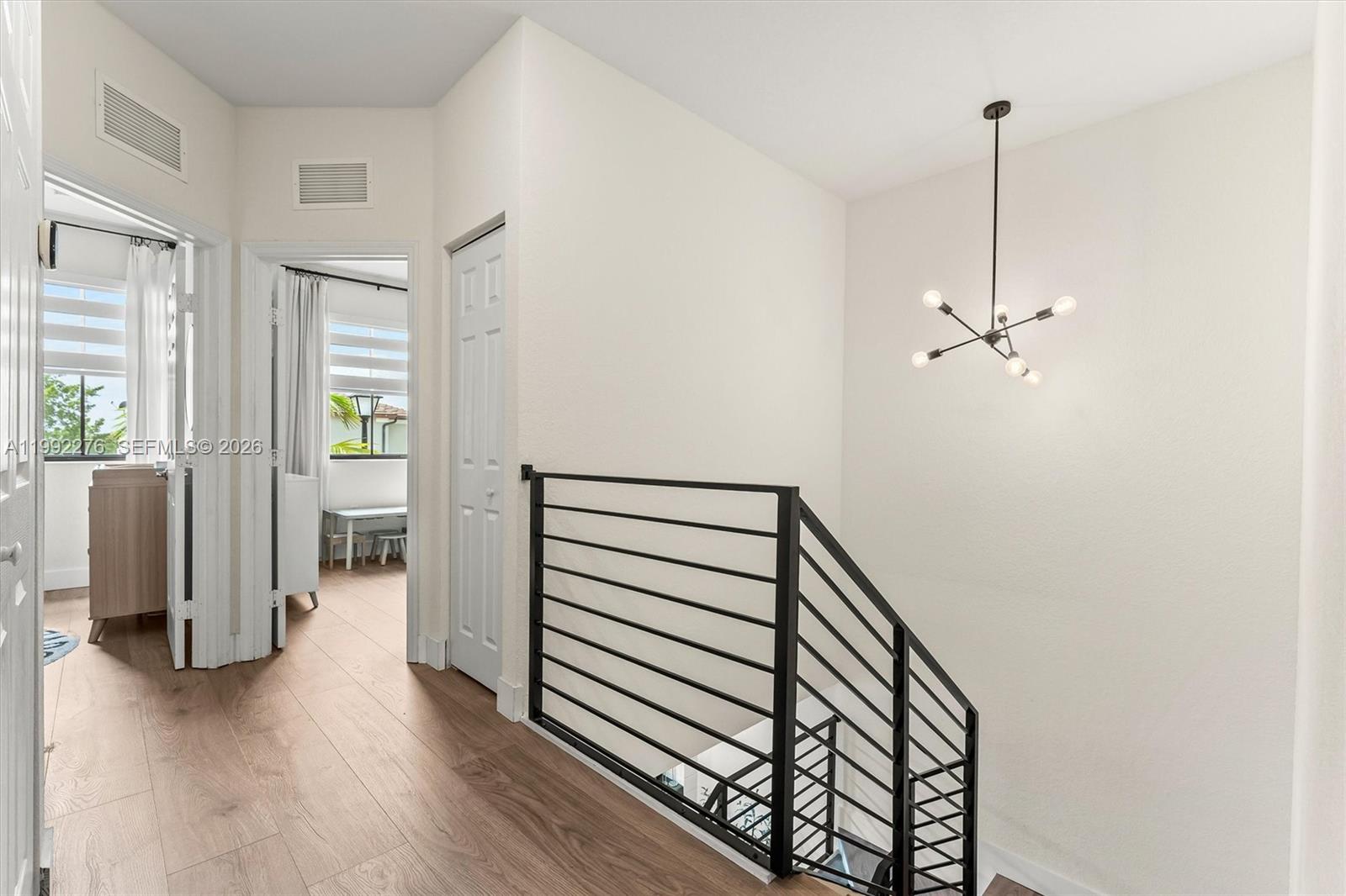 10487 West 34th Court Hialeah, FL 33018 - Photo 25 of 57 a view of a hallway with entryway and wooden floor