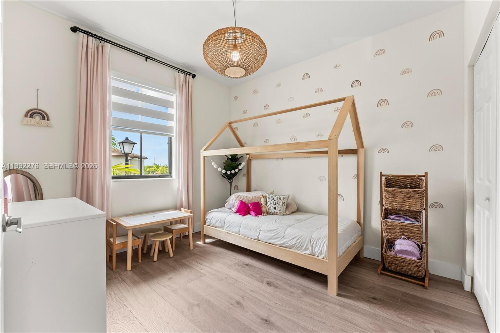 10487 West 34th Court Hialeah, FL 33018 - Photo 26 of 57 a bedroom with a bed and a chandelier