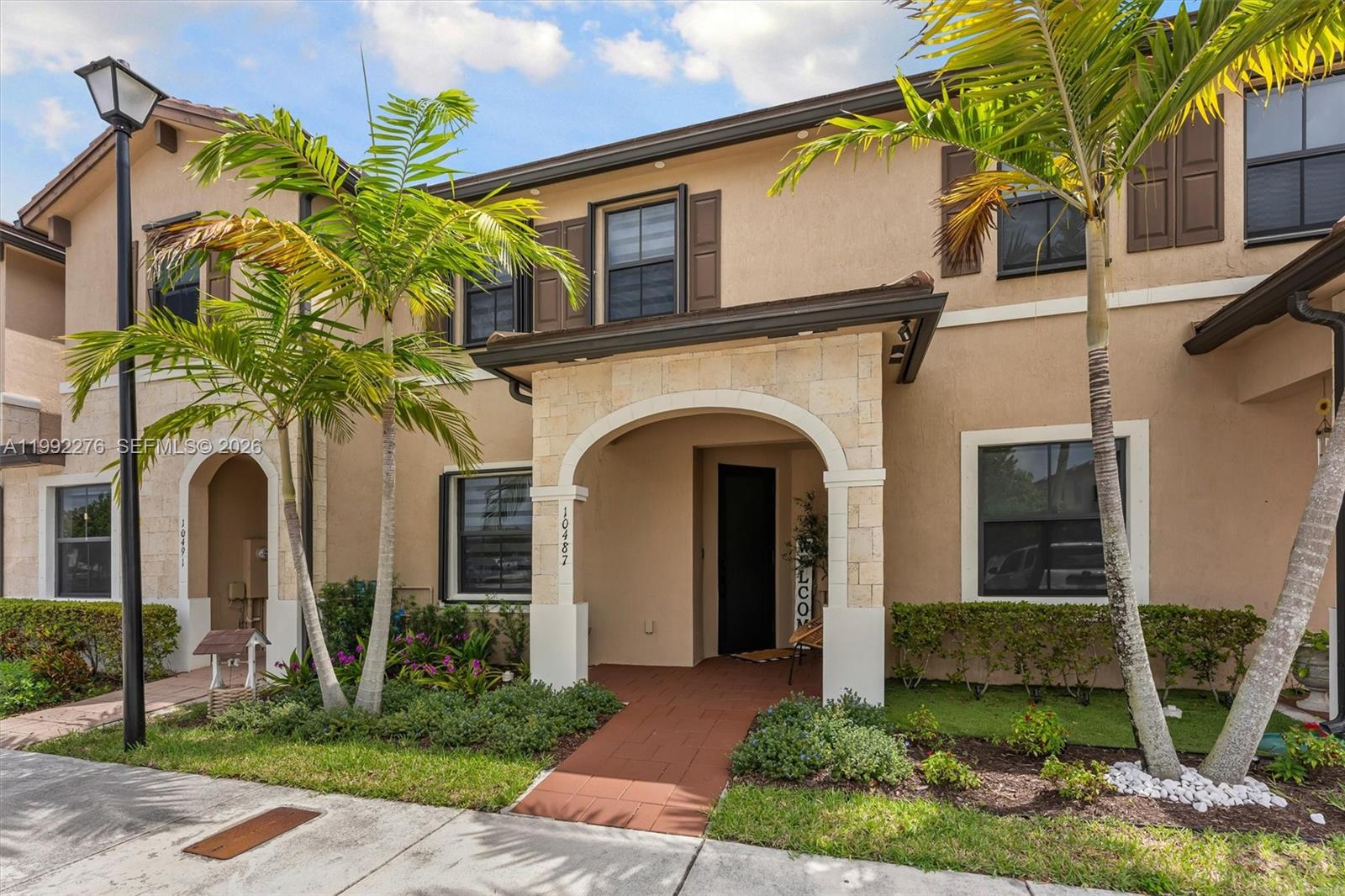 10487 West 34th Court Hialeah, FL 33018 - Photo 43 of 57 a front view of a house with garden
