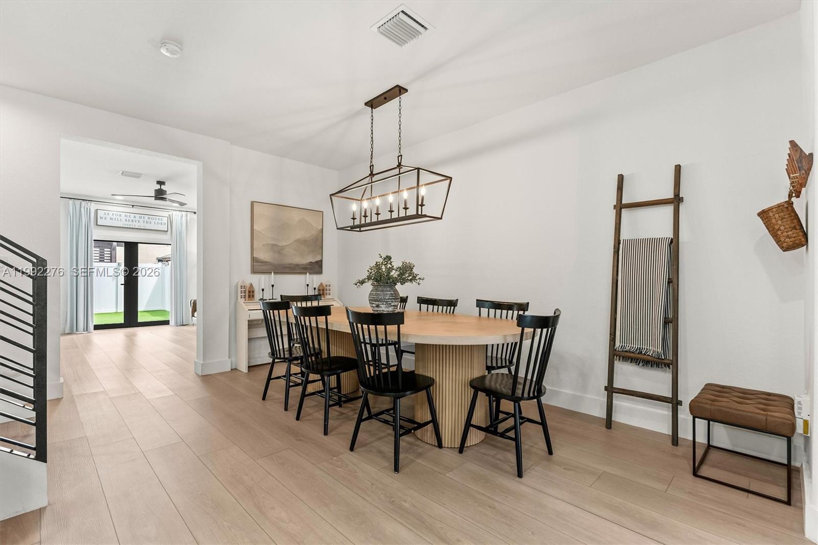 10487 West 34th Court Hialeah, FL 33018 - Photo 6 of 57 a view of a dining room with furniture wooden floor and chandelier