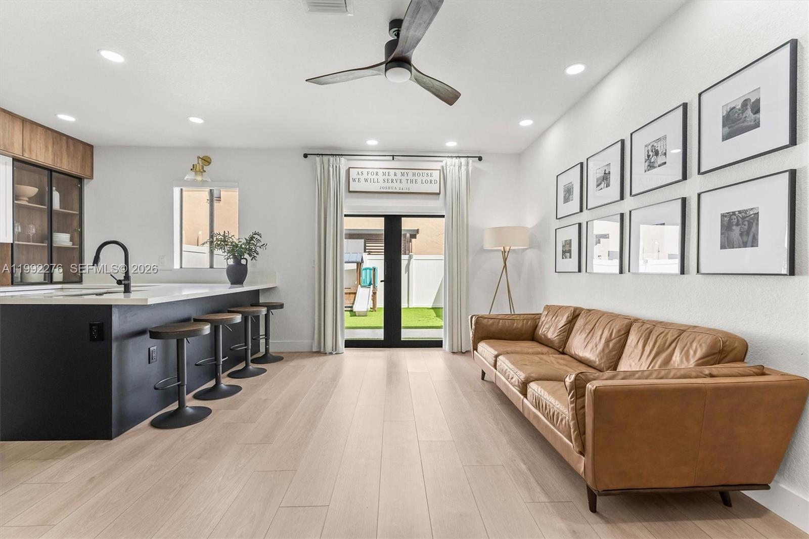 10487 West 34th Court Hialeah, FL 33018 - Photo 8 of 57 a living room with kitchen island furniture and a chandelier