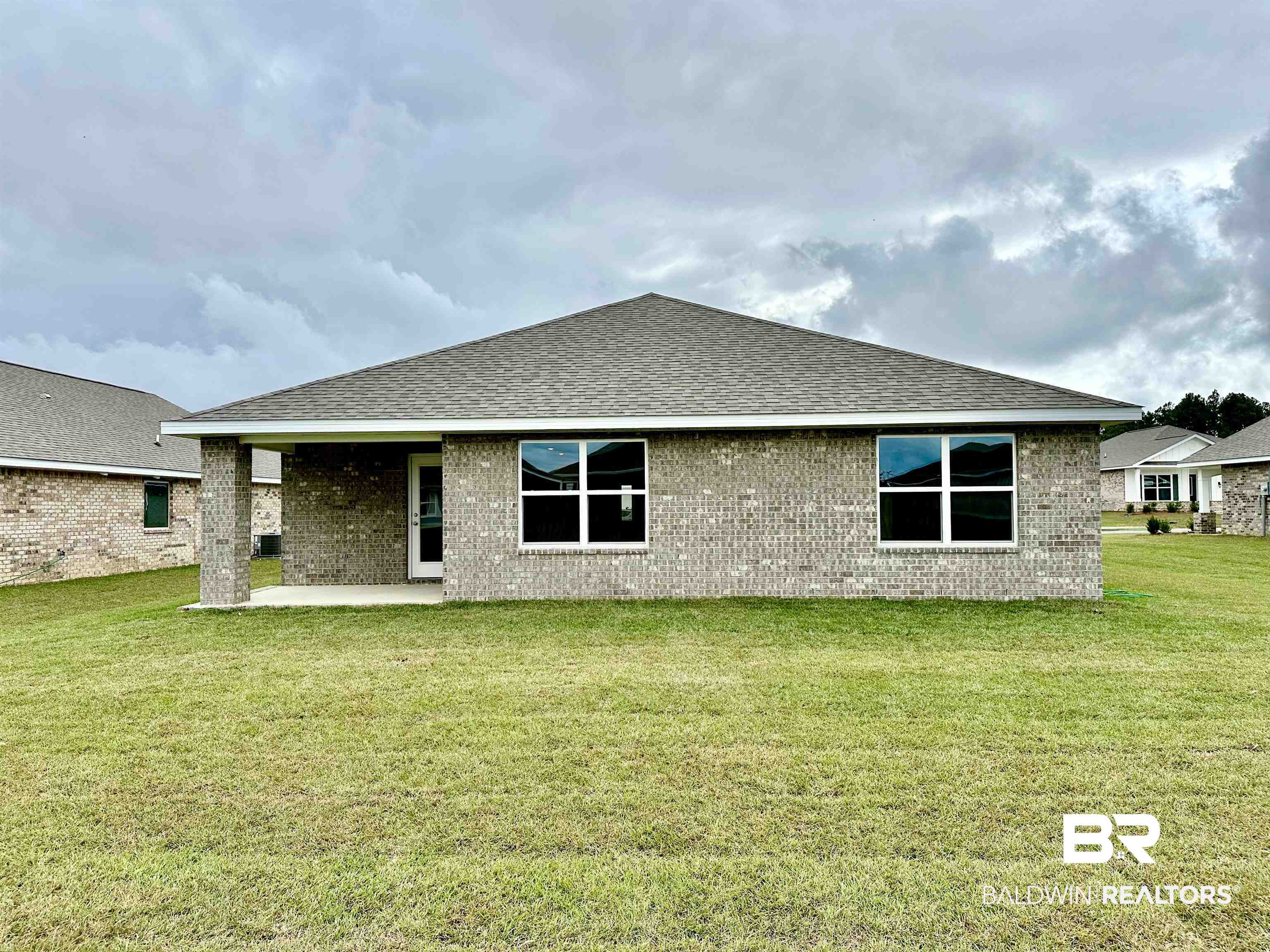 1238 Hayward Loop Foley, AL 36535 - Photo 5 of 46 Rear view of house with a patio and a lawn
