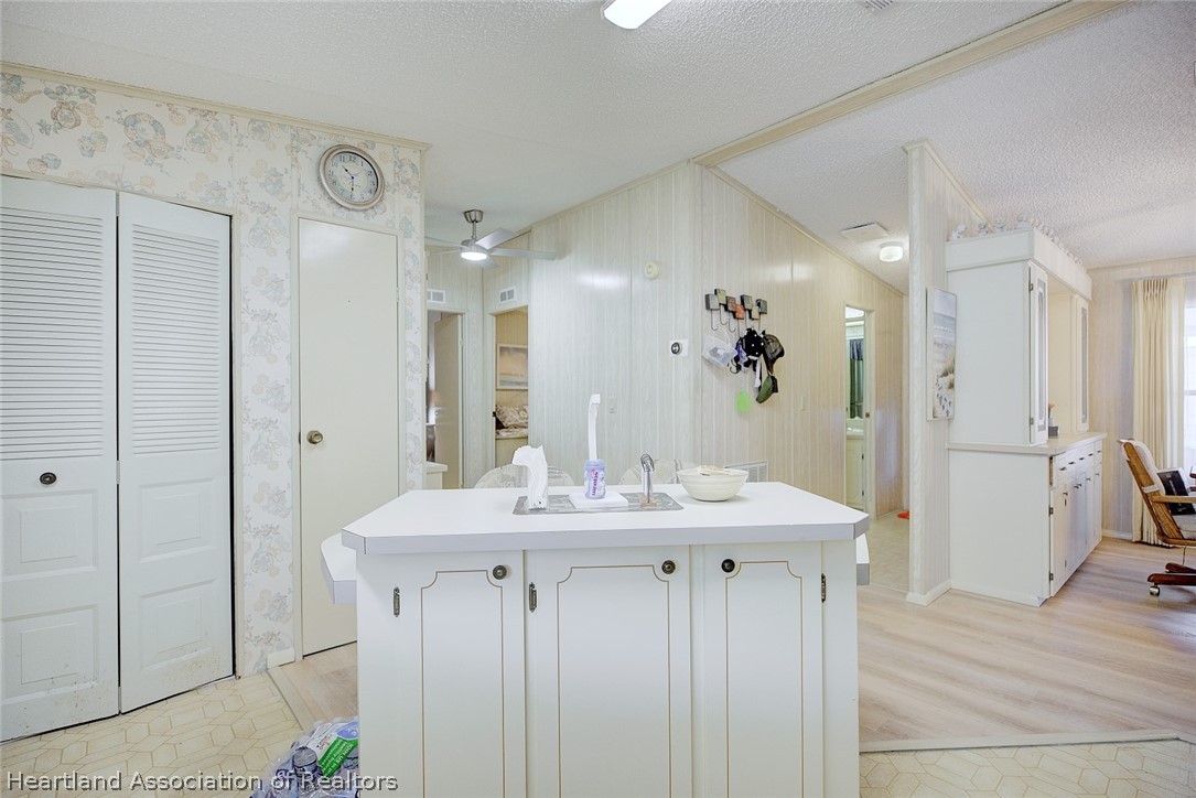 1571 Caribbean Road Sebring, FL 33870 - Photo 15 of 41 a view of a kitchen from the hallway