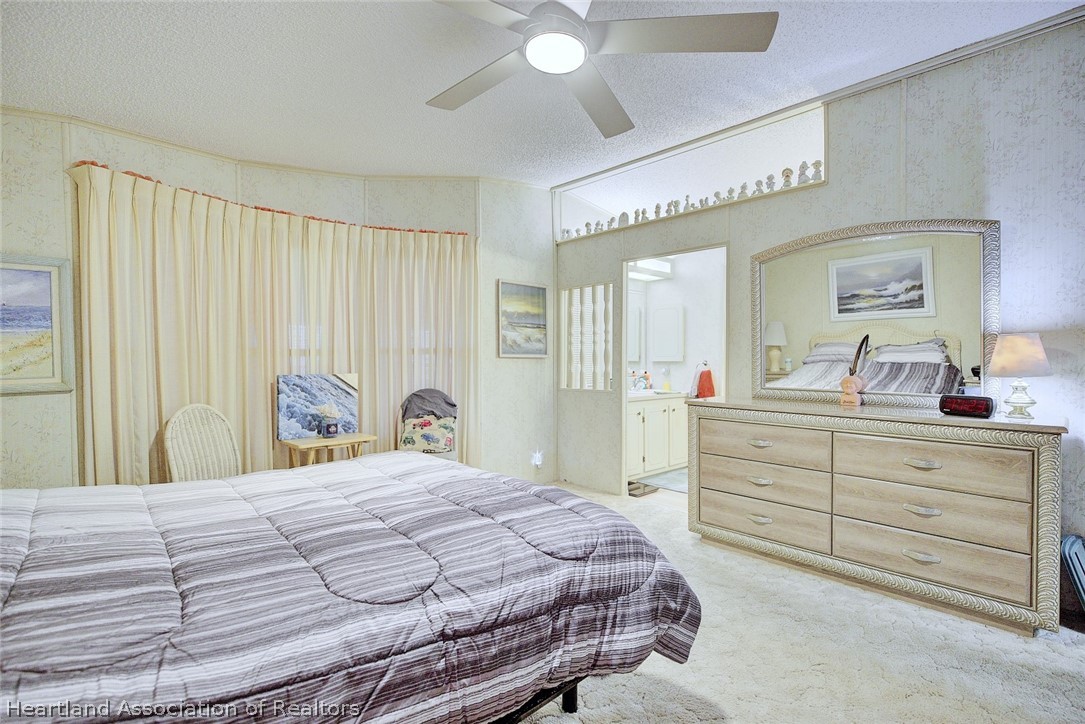 1571 Caribbean Road Sebring, FL 33870 - Photo 20 of 41 a bedroom with a bed and a dresser