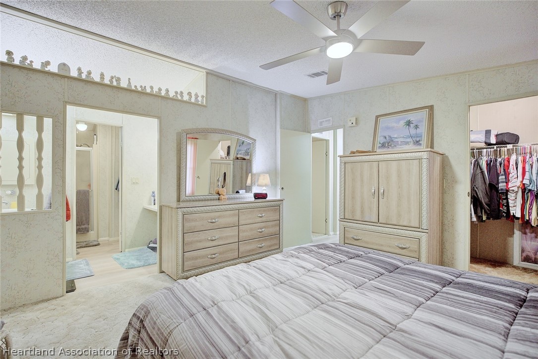 1571 Caribbean Road Sebring, FL 33870 - Photo 21 of 41 a bedroom with a bed and a chandelier