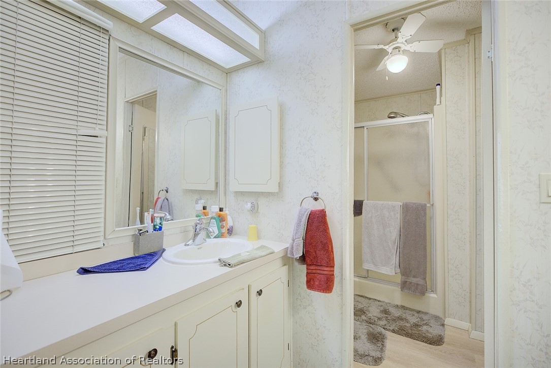 1571 Caribbean Road Sebring, FL 33870 - Photo 23 of 41 a bathroom with a sink and a mirror