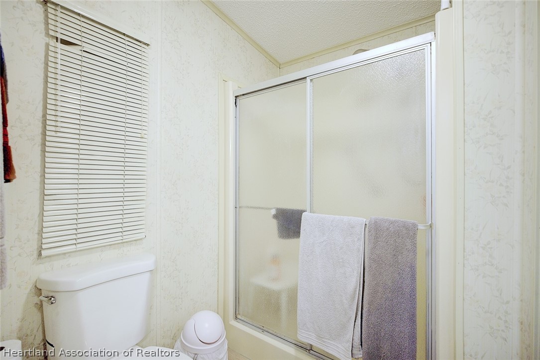 1571 Caribbean Road Sebring, FL 33870 - Photo 24 of 41 a bathroom with a shower and a toilet
