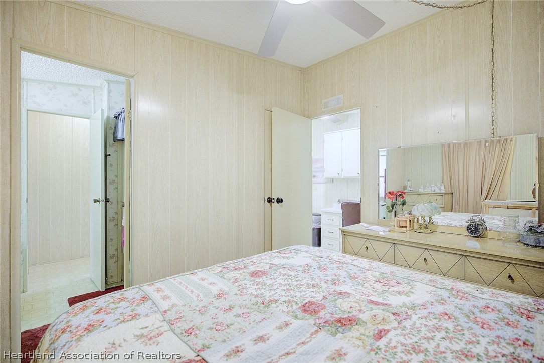 1571 Caribbean Road Sebring, FL 33870 - Photo 26 of 41 a bedroom with a bed and a dresser