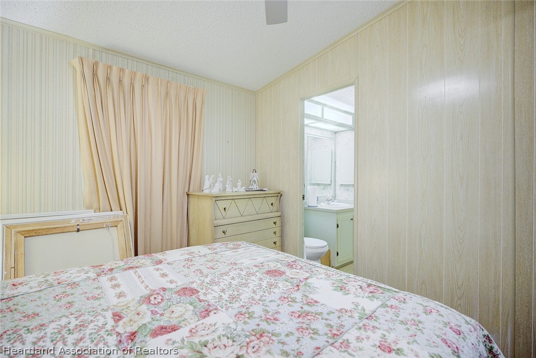 1571 Caribbean Road Sebring, FL 33870 - Photo 27 of 41 a bedroom with a bed and a window