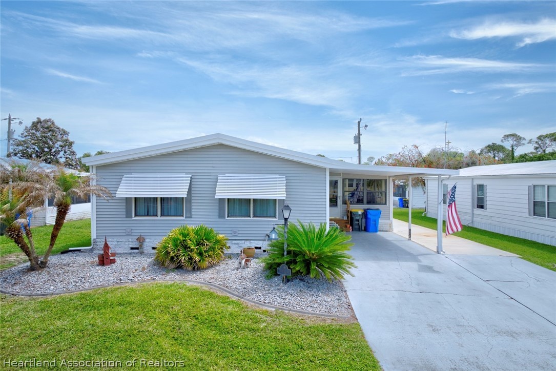 1571 Caribbean Road Sebring, FL 33870 - Photo 3 of 41 a view of an house with backyard and patio