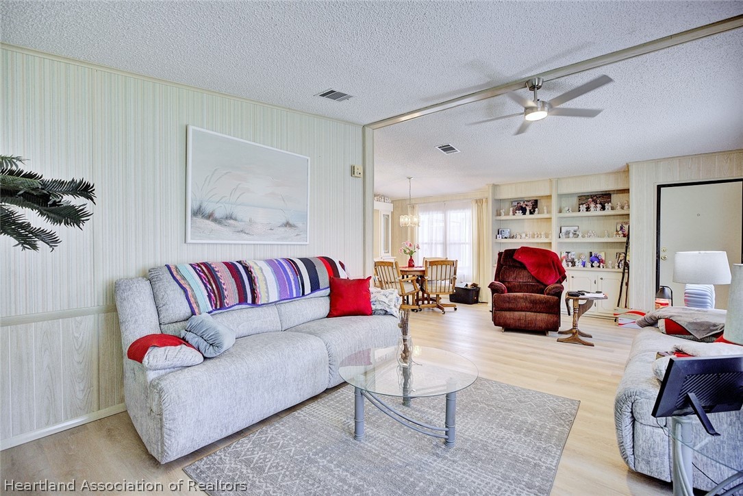 1571 Caribbean Road Sebring, FL 33870 - Photo 8 of 41 a living room with furniture and a lamp