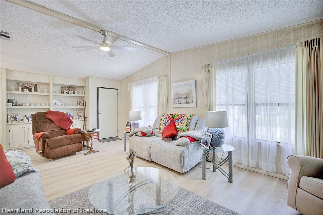 1571 Caribbean Road Sebring, FL 33870 - Photo 9 of 41 a living room with furniture and a chandelier