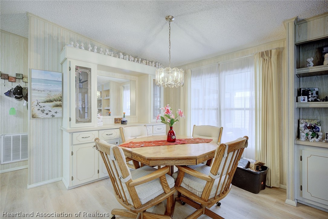 1571 Caribbean Road Sebring, FL 33870 - Photo 10 of 41 a dining room with furniture and window