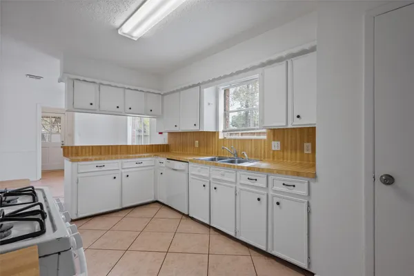 a kitchen with sink refrigerator and stove