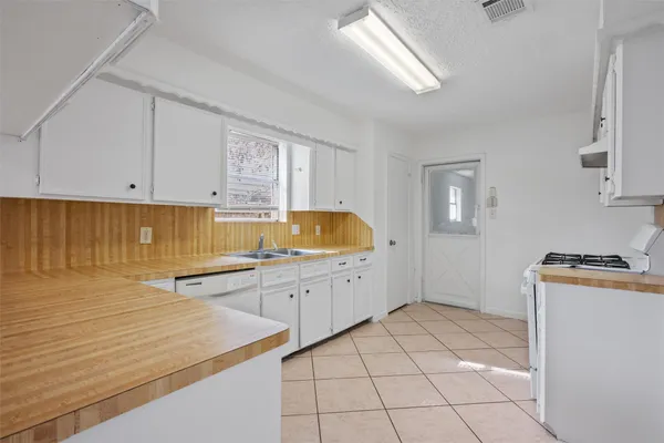 a kitchen with lot of cabinets and appliances