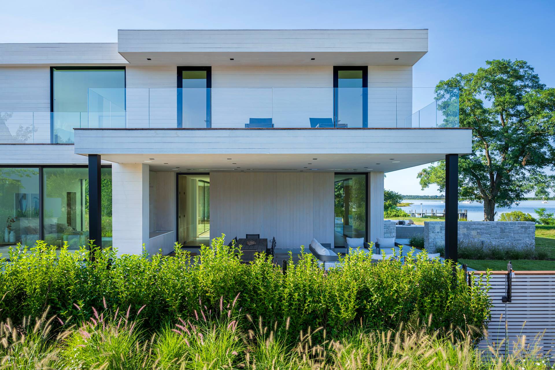1 Pandion Road Shelter Island, NY 11964 - Photo 23 of 32 a view of a house with a small yard plants and large tree