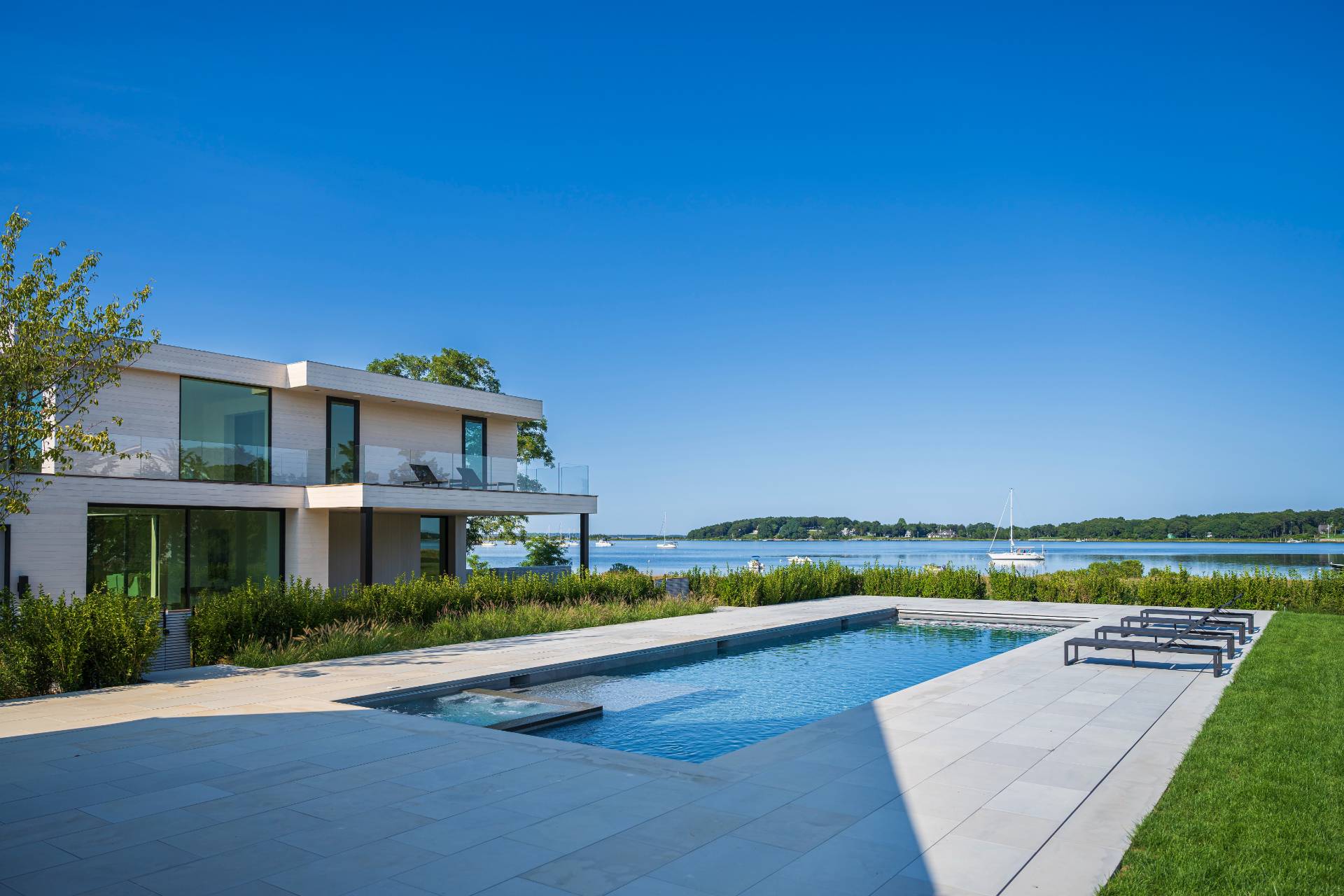 1 Pandion Road Shelter Island, NY 11964 - Photo 3 of 32 a front view of a house with garden and swimming pool