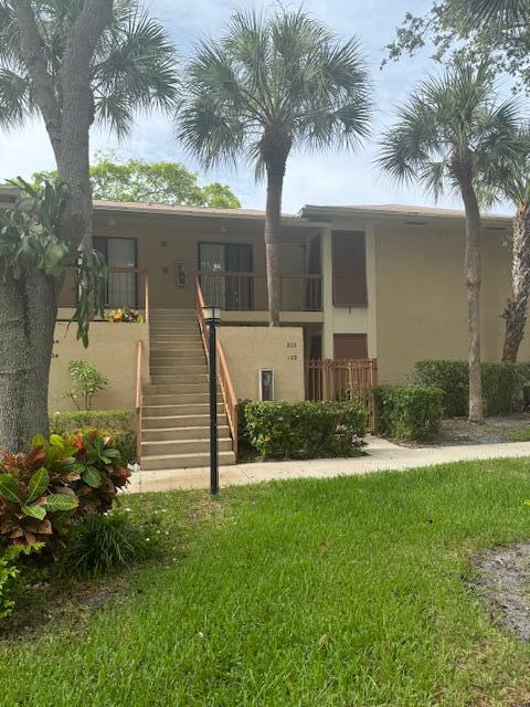 3939 Northeast 5th Avenue, Unit B203 Boca Raton, FL 33431 - Photo 13 of 15 front view of a house with a yard