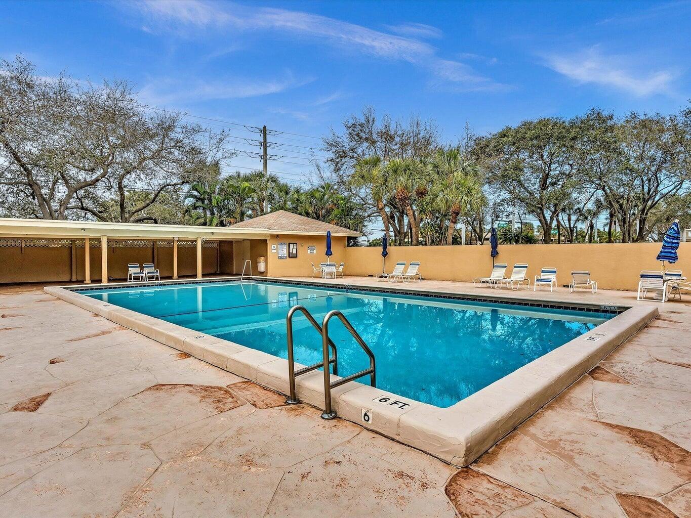 3939 Northeast 5th Avenue, Unit B203 Boca Raton, FL 33431 - Photo 4 of 15 a view of a patio with a table and chairs
