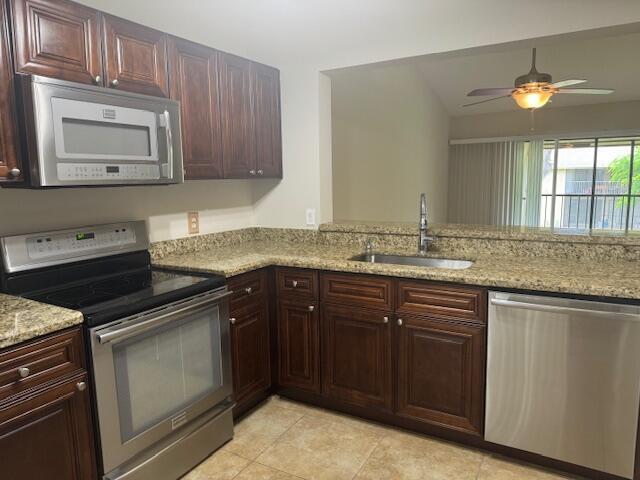 3939 Northeast 5th Avenue, Unit B203 Boca Raton, FL 33431 - Photo 8 of 15 a kitchen with granite countertop a sink and cabinets