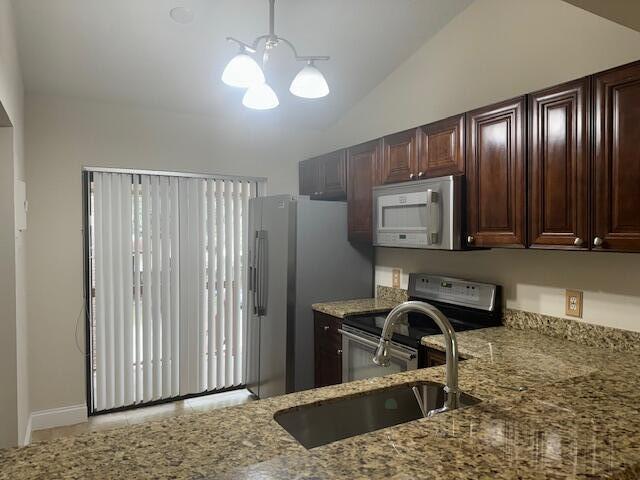 3939 Northeast 5th Avenue, Unit B203 Boca Raton, FL 33431 - Photo 9 of 15 a view of a workspace with furniture and chandelier
