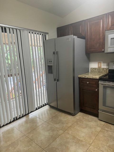 3939 Northeast 5th Avenue, Unit B203 Boca Raton, FL 33431 - Photo 10 of 15 a kitchen with stainless steel appliances a refrigerator and a sink