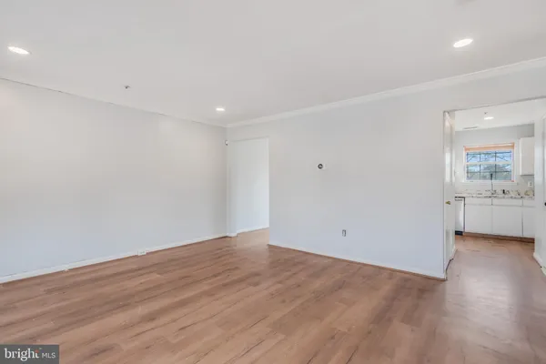 a view of a room with wooden floor and sink