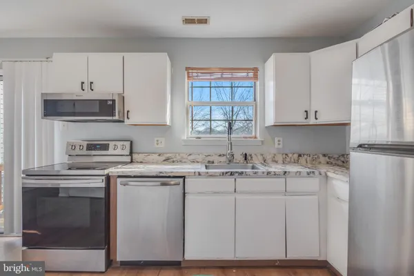 a kitchen with appliances cabinets and a sink