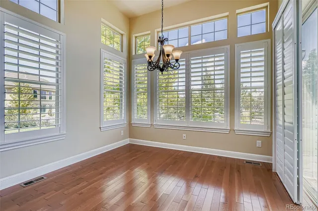 a view of a room with wooden floor and a window