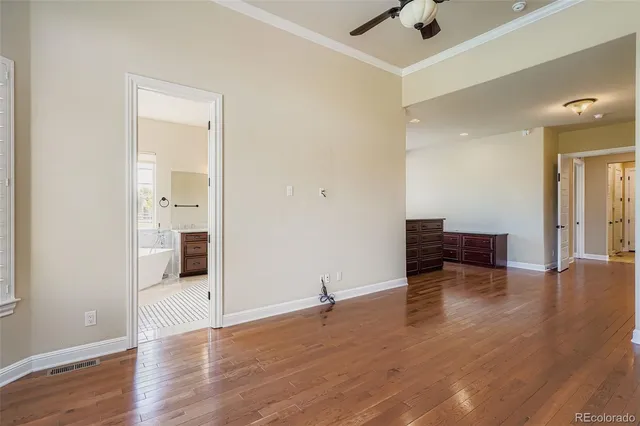 a view of empty room with wooden floor