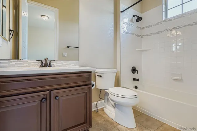 a bathroom with a sink toilet vanity and shower