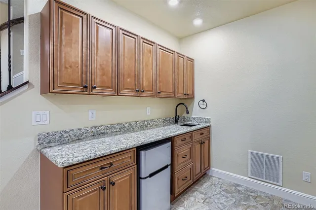 a kitchen with stainless steel appliances granite countertop a sink stove and cabinets