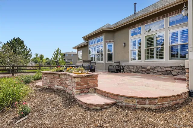 a swimming pool with outdoor seating and yard