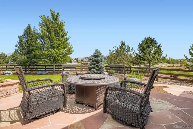 a view of a chairs and table in the balcony