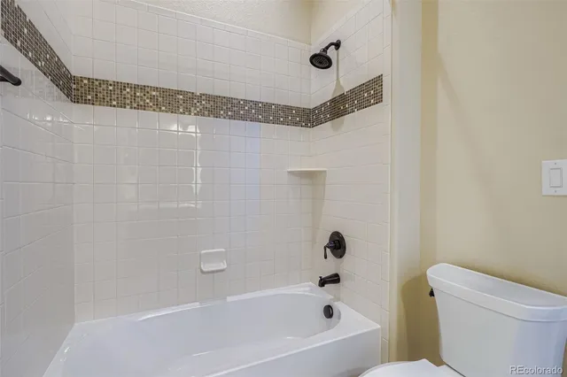 a bathroom with a bathtub and a toilet