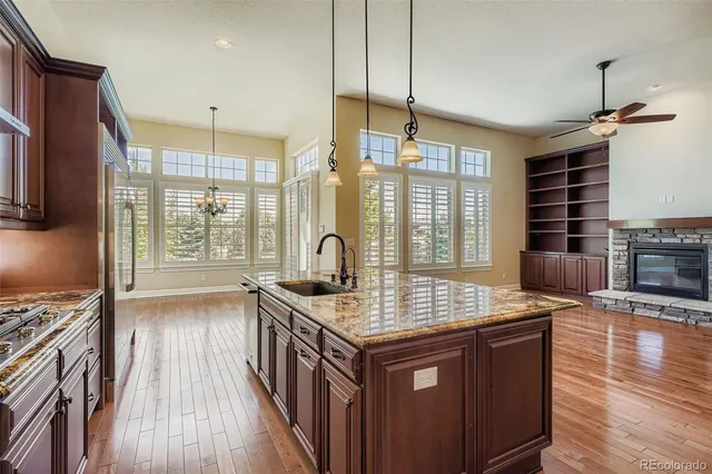a kitchen with sink stove and cabinets