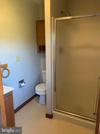 a bathroom with a toilet and a shower