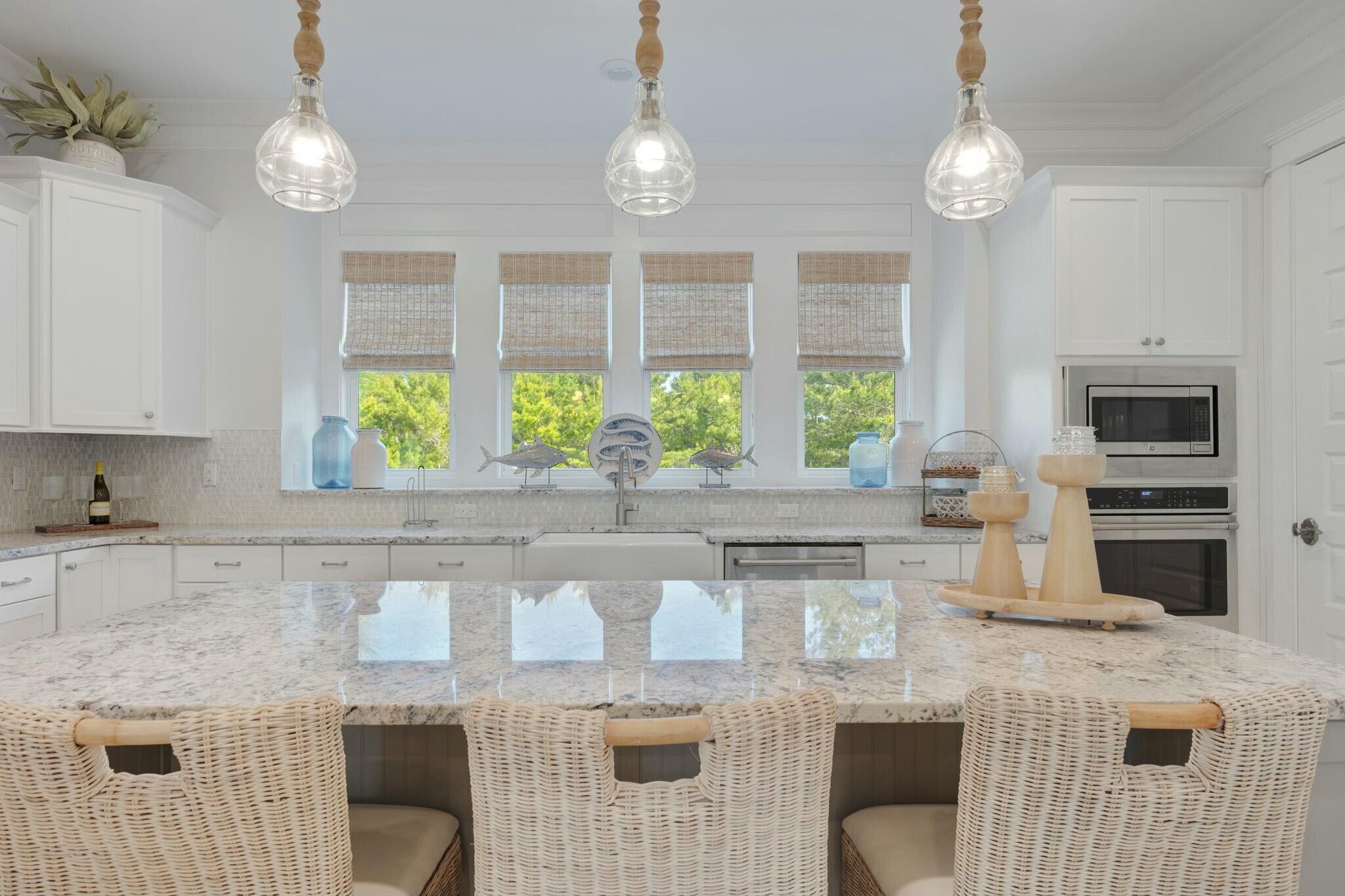 166 Clipper St Inlet Beach Inlet Beach, FL 32461 - Photo 12 of 71 a kitchen with stainless steel appliances granite countertop a stove a sink a counter space and cabinets