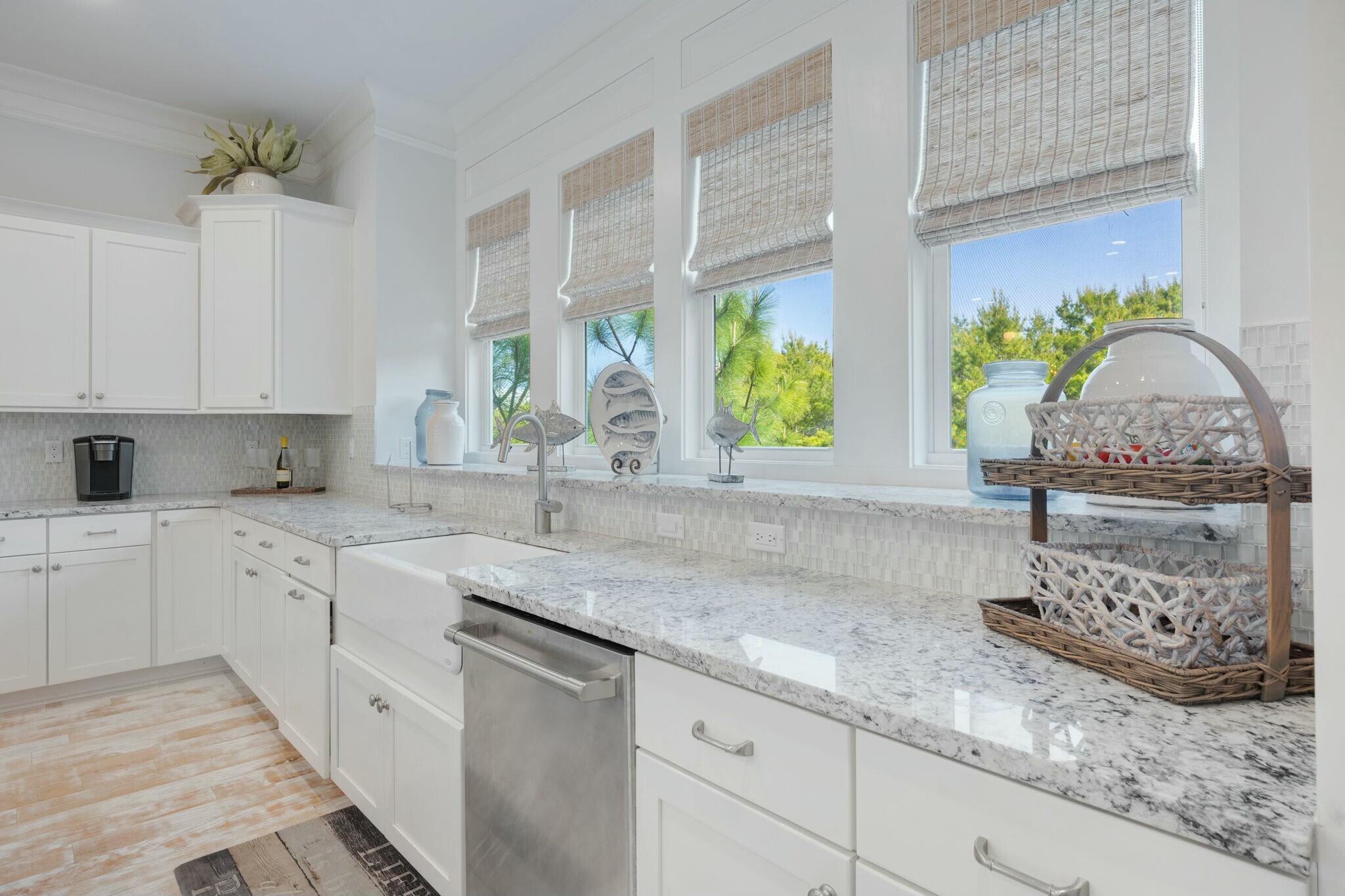166 Clipper St Inlet Beach Inlet Beach, FL 32461 - Photo 14 of 71 a kitchen with stainless steel appliances granite countertop a sink white cabinets and a granite counter tops