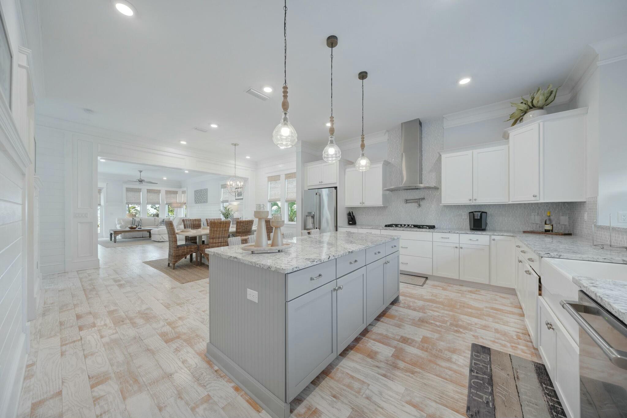 166 Clipper St Inlet Beach Inlet Beach, FL 32461 - Photo 16 of 71 a large kitchen with kitchen island a sink a stove a center island a dining table and chairs