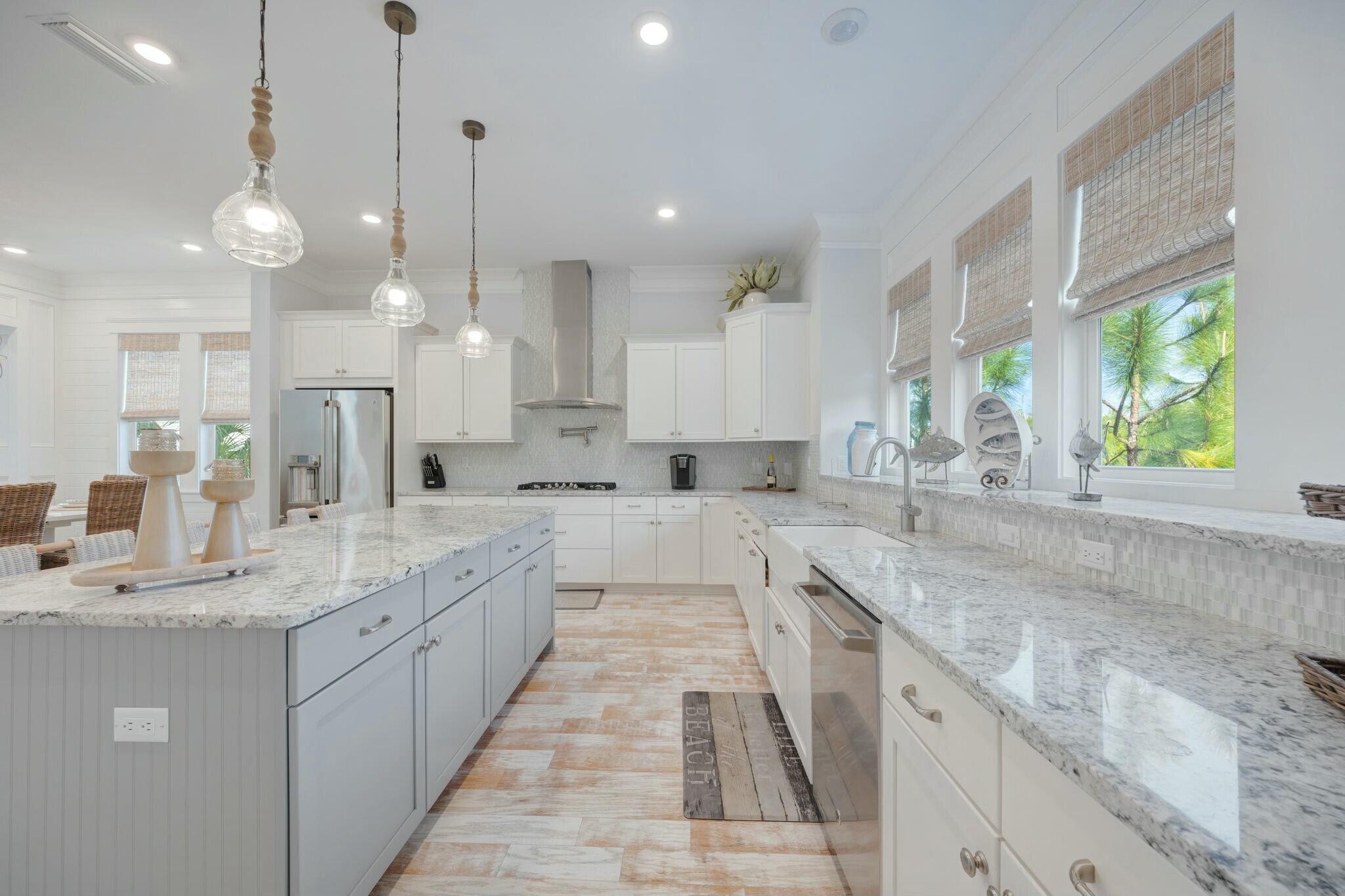 166 Clipper St Inlet Beach Inlet Beach, FL 32461 - Photo 17 of 71 a large kitchen with a large counter top a sink stainless steel appliances and windows