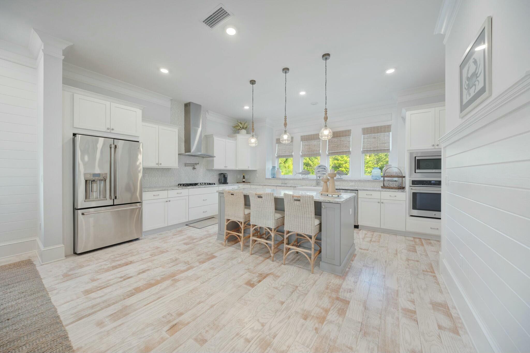 166 Clipper St Inlet Beach Inlet Beach, FL 32461 - Photo 20 of 71 a kitchen with stainless steel appliances a refrigerator a stove a sink dishwasher with a dining table and chairs