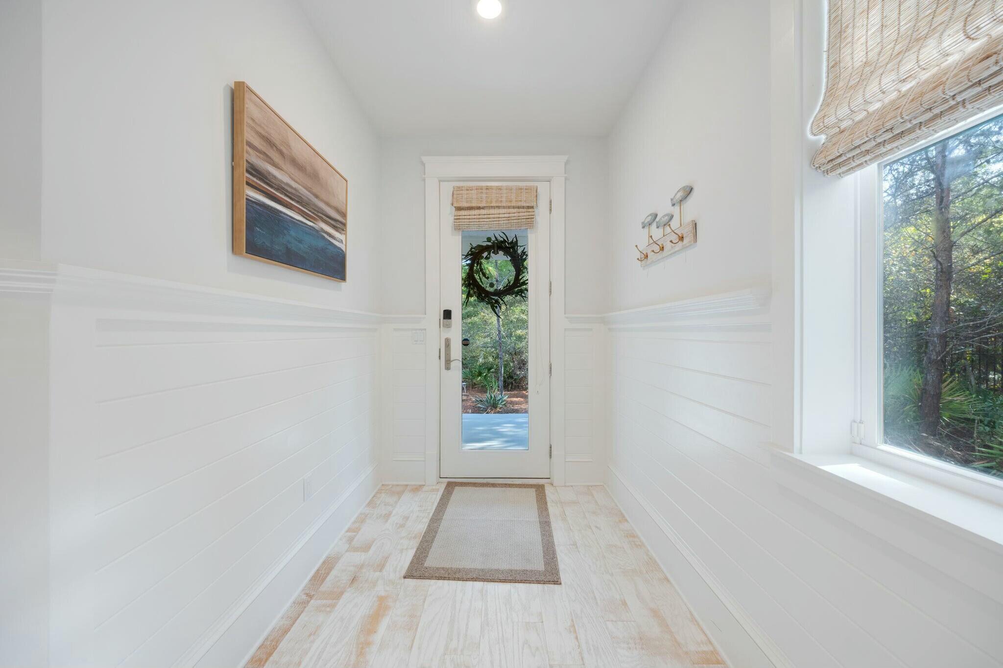 166 Clipper St Inlet Beach Inlet Beach, FL 32461 - Photo 55 of 71 a view of a hallway with wooden floor and a potted plant