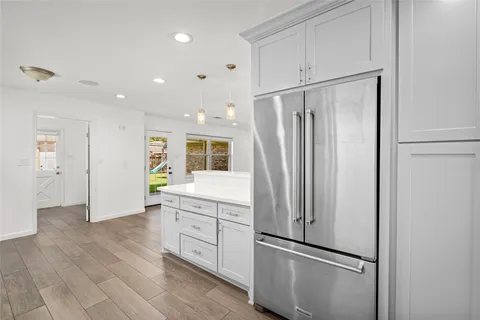 a kitchen with stainless steel appliances granite countertop a refrigerator and a refrigerator