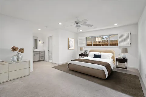 a spacious bedroom with a bed and a chandelier