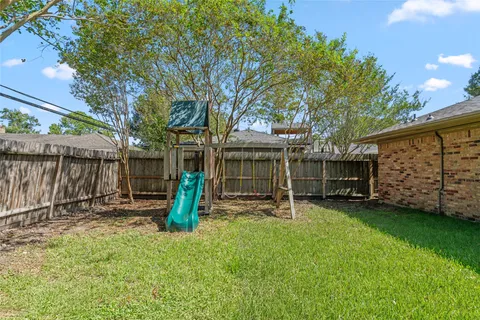 a view of a chair and table in backyard
