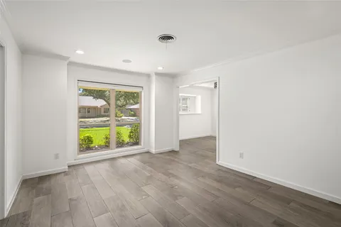 an empty room with windows and entrance