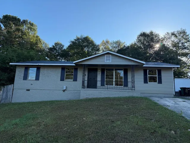 a front view of a house with a garden