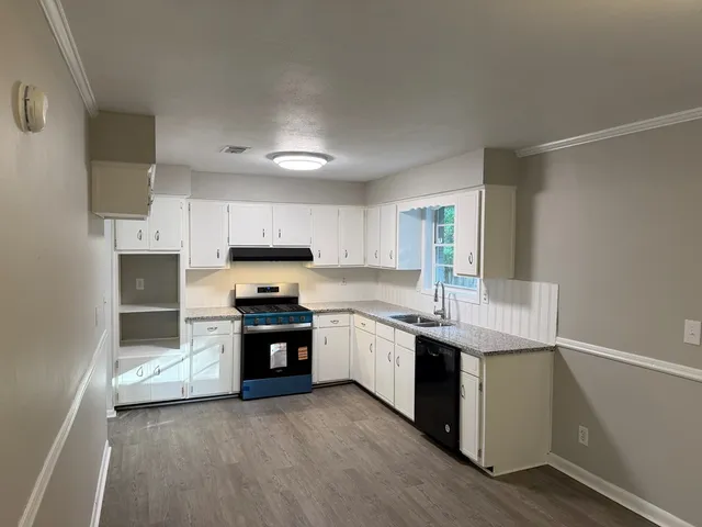 a kitchen with stainless steel appliances granite countertop a stove and a sink